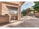 Covered outdoor kitchen boasts stainless steel grill and fridge, perfect for backyard gatherings at 2799 E Jade Pl, Chandler, AZ 85286