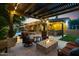 Outdoor living area boasts a fire pit, seating area, a built-in barbecue and serene water feature at 2799 E Jade Pl, Chandler, AZ 85286