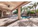 Covered patio with built-in grill, ceiling fan, and views of the pool and backyard at 2799 E Jade Pl, Chandler, AZ 85286