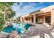 Private backyard featuring a custom pool with rock features, spa, and covered patio at 2799 E Jade Pl, Chandler, AZ 85286