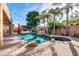 Beautiful backyard oasis featuring pool with rock accents, spa, and lush tropical landscaping at 2799 E Jade Pl, Chandler, AZ 85286