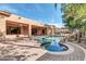 Backyard with custom pool, rock features, lush landscaping, and covered patio at 2799 E Jade Pl, Chandler, AZ 85286
