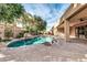 Beautiful backyard pool with rock waterfall feature and covered patio for outdoor entertaining at 2799 E Jade Pl, Chandler, AZ 85286