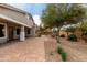 Paver patio with mature trees and minimal landscaping at 3020 E Tiffany Way, Gilbert, AZ 85298