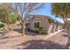 Backyard with rock landscaping, trees, and a brick paver patio at 3020 E Tiffany Way, Gilbert, AZ 85298