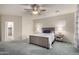 This primary bedroom features neutral walls, plush carpet, and stylish ceiling fan and light fixture at 3020 E Tiffany Way, Gilbert, AZ 85298