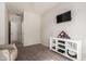 This bonus room is versatile, with a TV, built-in shelving, and a modern ceiling fan at 3020 E Tiffany Way, Gilbert, AZ 85298