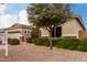 Home with a neatly maintained front yard, mature trees, and a private entrance with a well-kept lawn at 3020 E Tiffany Way, Gilbert, AZ 85298