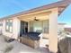 Cozy backyard patio featuring a hot tub, ceiling fan, and adjacent outdoor seating area at 357 E Las Puertas Ln, Queen Creek, AZ 85140
