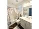Well-lit bathroom featuring a decorative shower curtain, white vanity, and a toilet with coordinated accents at 357 E Las Puertas Ln, Queen Creek, AZ 85140