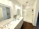 Bathroom featuring a double vanity with framed mirrors and glass-enclosed shower at 357 E Las Puertas Ln, Queen Creek, AZ 85140