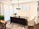 Bright dining area with a wooden table, upholstered chairs, and large windows at 357 E Las Puertas Ln, Queen Creek, AZ 85140