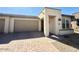Attractive one-story home with a neutral-toned exterior, a paved driveway, and low maintenance front yard landscaping at 357 E Las Puertas Ln, Queen Creek, AZ 85140