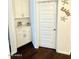 Hallway with built-in cabinets, a door to an unknown room, and a coastal decor theme at 357 E Las Puertas Ln, Queen Creek, AZ 85140