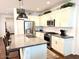 A modern kitchen with a central island, bar seating, stainless steel appliances, and sleek cabinetry at 357 E Las Puertas Ln, Queen Creek, AZ 85140