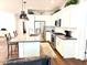 Modern kitchen featuring stainless steel appliances, white cabinetry, and a kitchen island at 357 E Las Puertas Ln, Queen Creek, AZ 85140