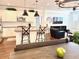 Open kitchen and living area featuring an island with bar stools, and stainless steel appliances at 357 E Las Puertas Ln, Queen Creek, AZ 85140