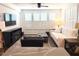 Bright living area featuring natural light, modern furniture, and connecting to kitchen area at 357 E Las Puertas Ln, Queen Creek, AZ 85140
