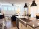Open living space with oversized windows and shutters, seamlessly connected to the modern kitchen area at 357 E Las Puertas Ln, Queen Creek, AZ 85140