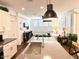 Living room and kitchen area featuring bar stools, a kitchen island and stainless steel appliances at 357 E Las Puertas Ln, Queen Creek, AZ 85140