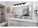 Bright bathroom featuring double sinks, a large mirror, and modern fixtures at 3906 W Pershing Ave, Phoenix, AZ 85029