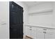 Convenient laundry room featuring white cabinetry and a modern design at 3906 W Pershing Ave, Phoenix, AZ 85029