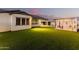 Beautiful backyard featuring an outdoor bar, pool, and manicured lawn, seamlessly blending entertainment and relaxation at 4247 E Tonto Pl, Chandler, AZ 85249