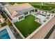 Expansive backyard featuring a sparkling pool, lush green lawn, and a cozy pergola for outdoor entertaining at 4247 E Tonto Pl, Chandler, AZ 85249