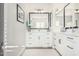 Bright bathroom featuring white cabinetry, sleek black hardware, and contemporary fixtures at 4247 E Tonto Pl, Chandler, AZ 85249