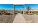 Welcoming community entrance with a metal canopy and landscaped walkway leading to green space at 4247 E Tonto Pl, Chandler, AZ 85249