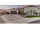Stunning exterior view of home featuring a brick driveway, desert landscaping and a two-car garage at 4247 E Tonto Pl, Chandler, AZ 85249