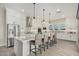 Elegant kitchen with a large island, barstool seating, and modern stainless steel appliances at 4247 E Tonto Pl, Chandler, AZ 85249