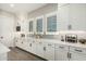 Well-lit kitchen boasts ample counter space, white cabinetry, and stylish backsplash at 4247 E Tonto Pl, Chandler, AZ 85249