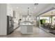 Modern kitchen with stainless steel appliances, large island, and seamless outdoor access at 4247 E Tonto Pl, Chandler, AZ 85249