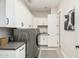 The laundry room has white cabinets and modern appliances at 4247 E Tonto Pl, Chandler, AZ 85249