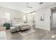 Cozy main bedroom with a bench, sliding door to the bathroom, and a ceiling fan at 4247 E Tonto Pl, Chandler, AZ 85249