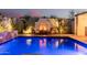 Relaxing backyard oasis featuring a pool, modern fireplace, and comfortable seating area, perfect for outdoor entertaining at 4247 E Tonto Pl, Chandler, AZ 85249