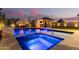 A luxurious pool and spa with an outdoor kitchen perfect for entertaining guests at 4247 E Tonto Pl, Chandler, AZ 85249