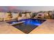 This backyard oasis features a pool, spa, and fireplace for outdoor entertaining at 4247 E Tonto Pl, Chandler, AZ 85249