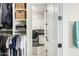 Well-organized walk-in closet leading to a laundry room with modern appliances at 4247 E Tonto Pl, Chandler, AZ 85249
