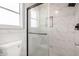 Modern bathroom featuring a glass shower with white marble tiles and updated fixtures at 5209 W Hatcher Rd, Glendale, AZ 85302