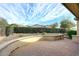 Charming backyard with a red brick patio, privacy hedge, and a beautifully landscaped desert landscape at 5405 S Marigold Way, Gilbert, AZ 85298