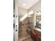 Modern tiled shower with a built-in seat and safety bars at 5405 S Marigold Way, Gilbert, AZ 85298