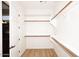 Walk-in closet with wood shelves, a clothes bar, and an attached door at 5405 S Marigold Way, Gilbert, AZ 85298
