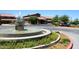 Charming clubhouse featuring lush landscaping, a circular driveway, and a water fountain at 5405 S Marigold Way, Gilbert, AZ 85298