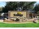 Community entrance featuring a stone monument with water feature and manicured landscaping at 5405 S Marigold Way, Gilbert, AZ 85298