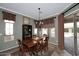 Formal dining room with decorative rug, chandelier, large windows, and access to patio at 5405 S Marigold Way, Gilbert, AZ 85298
