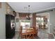 An elegant dining area with a dark wood table and a sliding glass door at 5405 S Marigold Way, Gilbert, AZ 85298