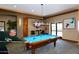 Spacious game room featuring a high quality billiard table and a decorative light fixture at 5405 S Marigold Way, Gilbert, AZ 85298