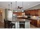 Open kitchen featuring a large granite island and modern stainless steel appliances at 5405 S Marigold Way, Gilbert, AZ 85298